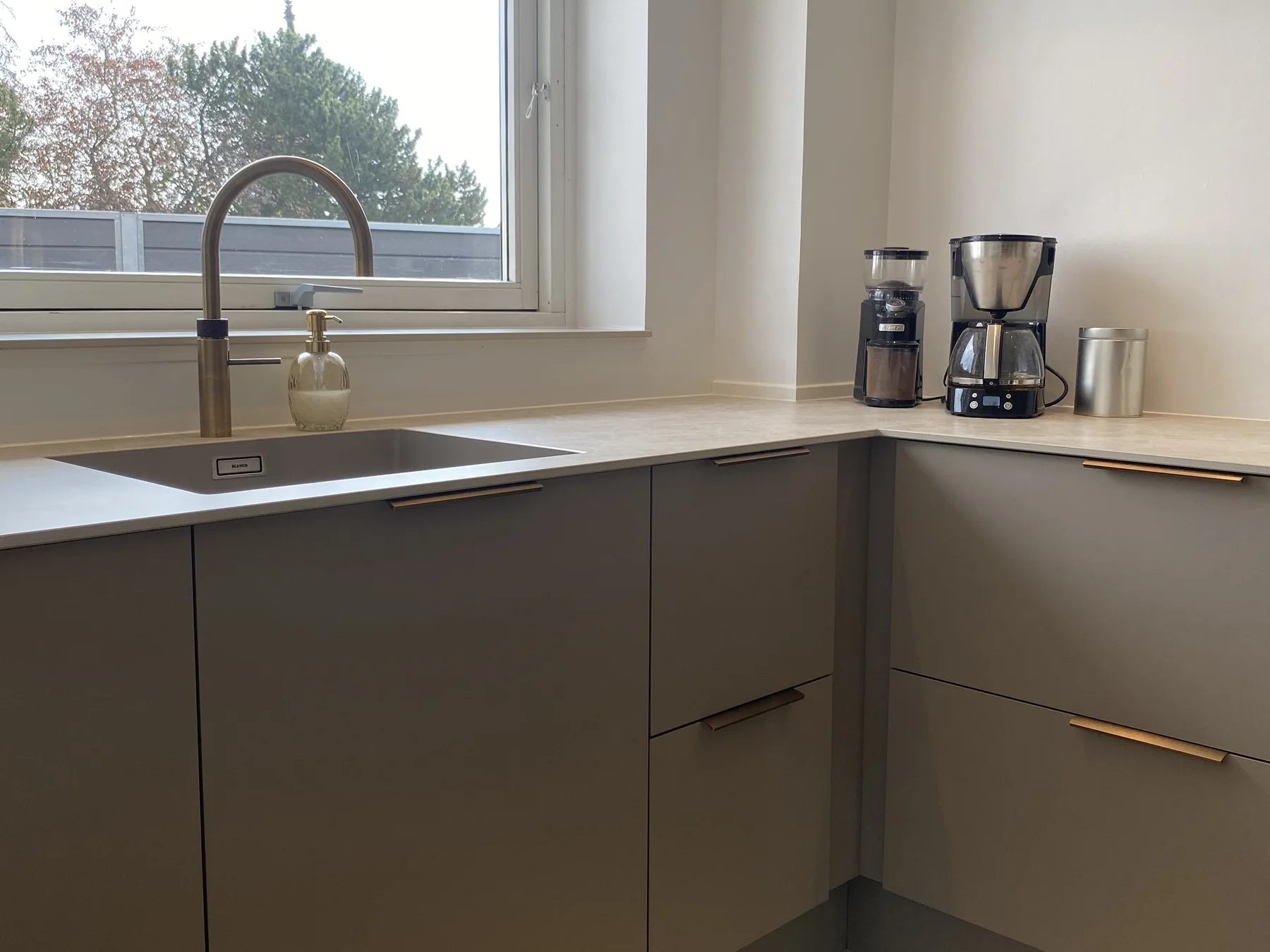 The completed kitchen with integrated cabinetry and new finishes