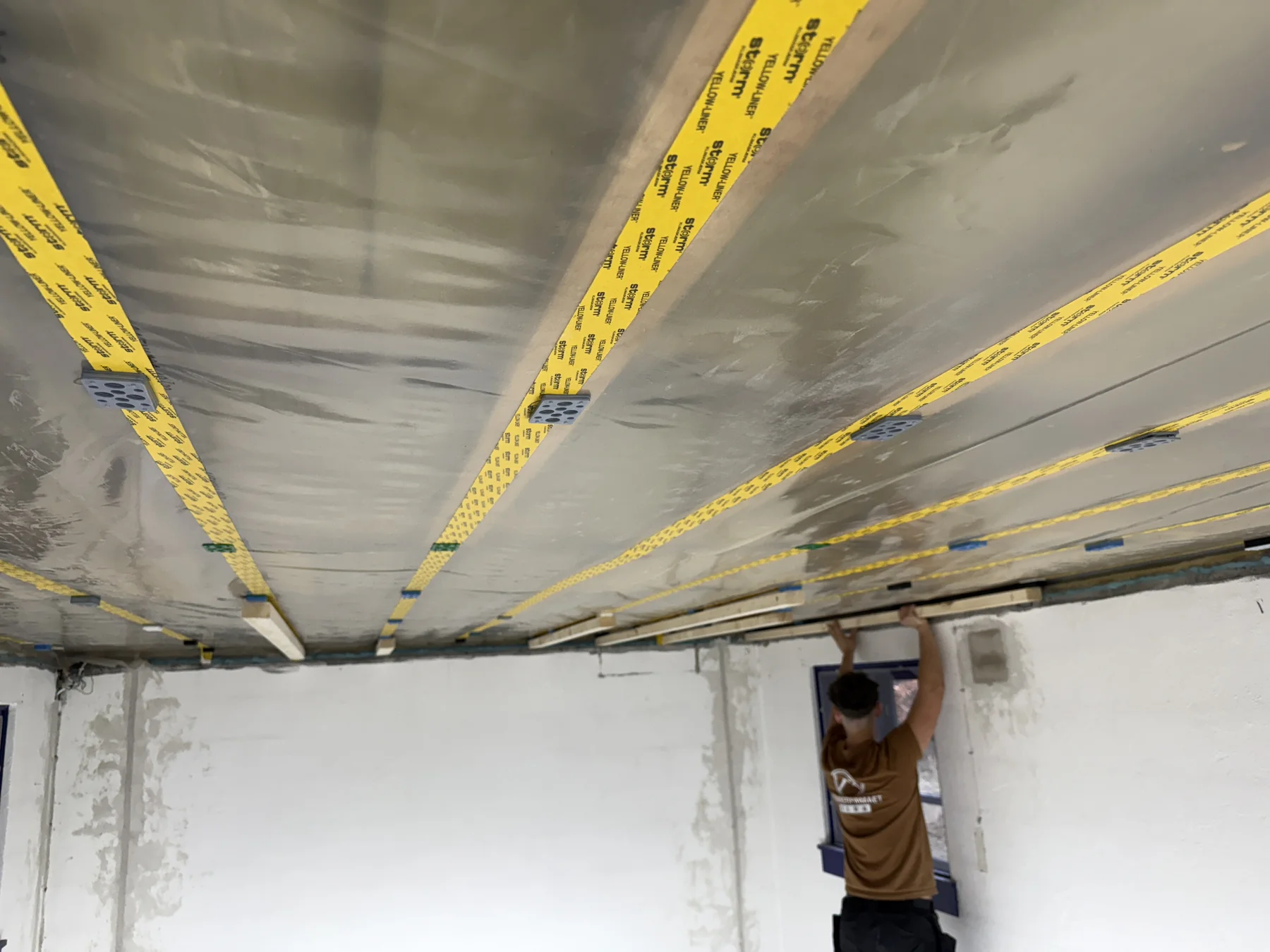 New battens and services above the tongue-and-groove ceiling