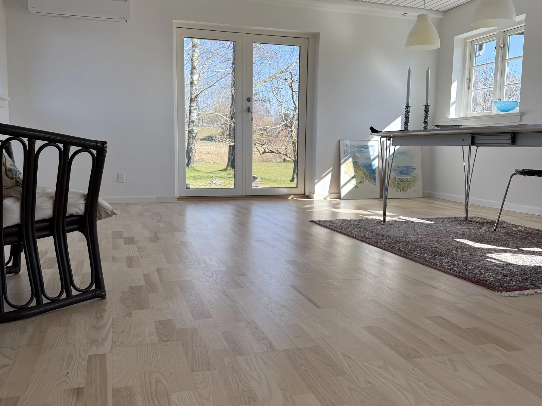 The completed kitchen and living area with restored timber floors
